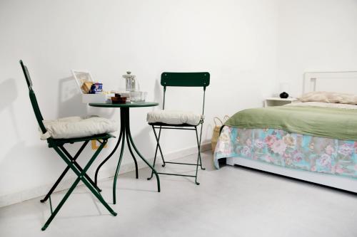 una camera da letto con un letto, due sedie e un tavolo di Mama's home a Napoli
