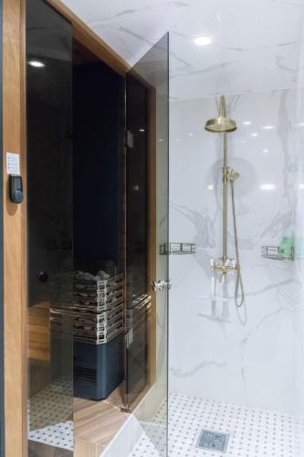 a shower with a glass door in a bathroom at Parlament in Tallinn