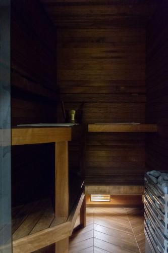 a sauna with wooden walls and a wooden table at Parlament in Tallinn
