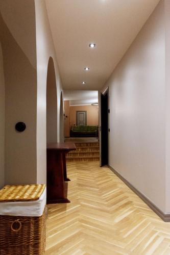 a hallway with a wooden floor and a table at Parlament in Tallinn