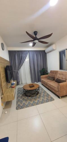 a living room with a couch and a ceiling fan at Ayesha Metrocity Staycation N-02 & N-5-03 in Kuching