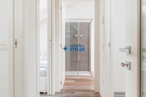 a hallway with a glass door with a sign on it at Condominio Aquileia in Lido di Jesolo