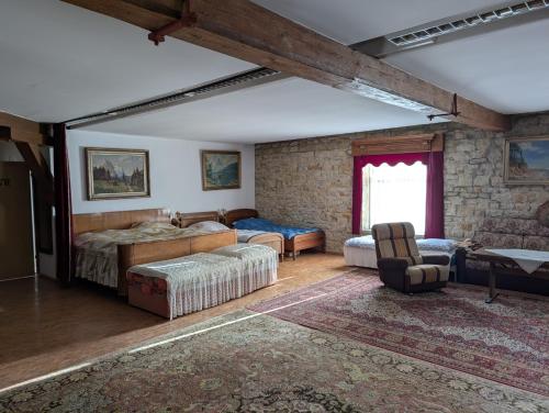 a bedroom with two beds and a stone wall at Pilgerunterkunft "Zum Bauernhof" in Egeln