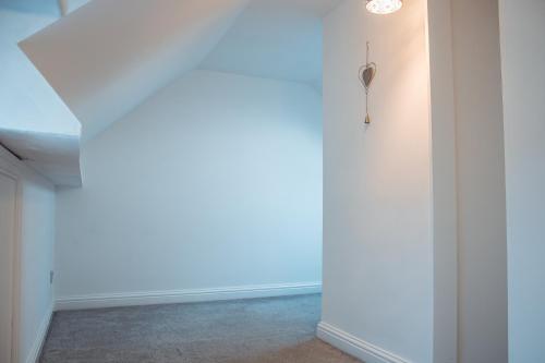an empty hallway with white walls and a ceiling at Spacious 4-Bed Home in Wetherby in Wetherby