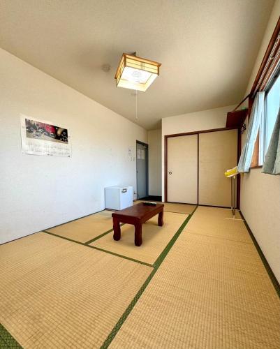 an empty room with a table and a door at ビジネスホテル美咲 in Sakaide