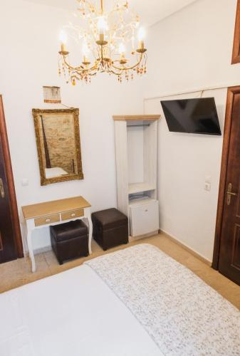 a bedroom with a bed and a chandelier at Tsopela Boutique Hotel in Skiathos Town