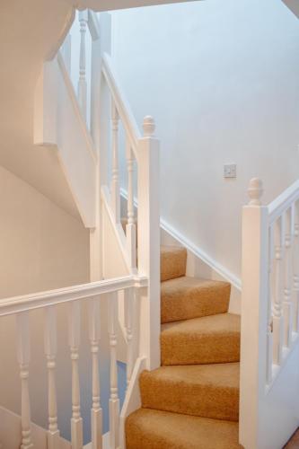 a staircase with white railings and orange carpet at Spacious 4-Bed Home in Wetherby in Wetherby