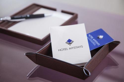 a box with a card and a pen on a table at HOTEL MYSTAYS PREMIER Kanazawa in Kanazawa