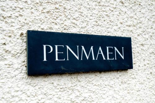 a sign on the side of a wall with the word pennemen at The Gower Hotel in Swansea