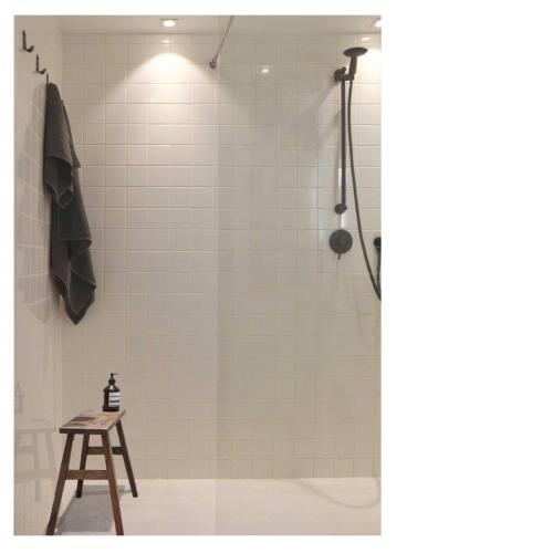 a shower stall with a stool in a bathroom at PLAISANCE Bouguenais - Appartement Nantes - PARKING GRATUIT in Bouguenais