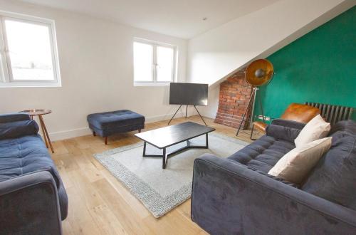 a living room with a couch and a table at The Loft Winchester in Winchester