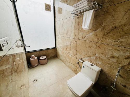 a bathroom with a white toilet and a shower at Hotel Runway Inn in Jodhpur