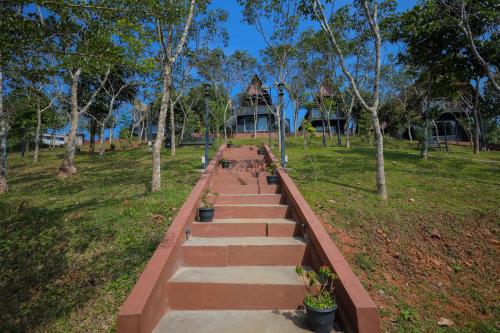 a set of stairs in a park with trees at Kap Korome Village Resort in Koroth