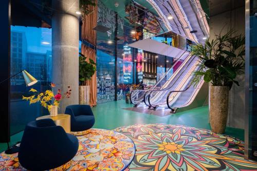 a room with a slide and two blue chairs at nhow Amsterdam Rai in Amsterdam