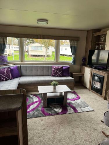 a living room with a couch and a table at 275 - Butlins Skegness, pet friendly and WiFi - Meadow Lakes Caravan & Lodge Hire in Ingoldmells