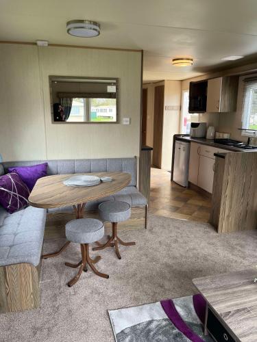 a living room with a table and a kitchen at 275 - Butlins Skegness, pet friendly and WiFi - Meadow Lakes Caravan & Lodge Hire in Ingoldmells