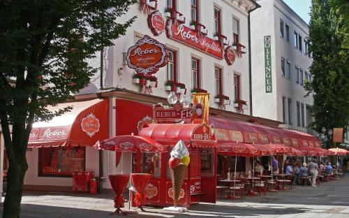 a restaurant with red umbrellas on a city street at Alpenschwänchen 4 - Saalachschwänchen in Bad Reichenhall