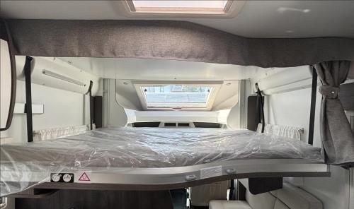 a large bed in the back of a camper van at Wypożyczalnia kamperów w Lubelskim! Bogata wersja! 5 miejsc Benimar Tessoro 463 in Łaziska