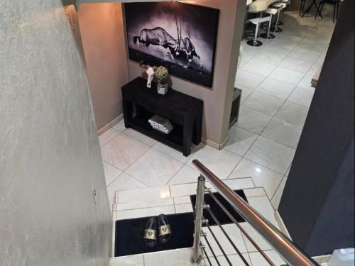 a living room with a flat screen tv on a wall at Batuka Damview Lodge in Tshakhuma