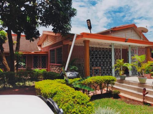 a house with an orange roof at Pearl Rangers Inn in Mbale
