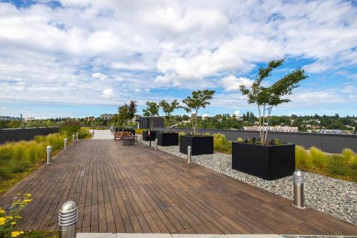 a boardwalk with trees on top of a building at U Place Urban Apartments by Sweetome in Seattle