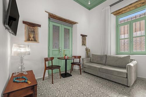 a living room with a couch and a table at Casa del Sol Suites in Rhodes Town