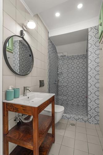 a bathroom with a sink and a toilet and a shower at Casa del Sol Suites in Rhodes Town