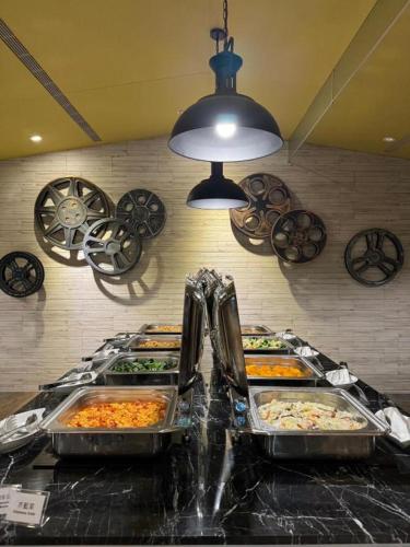 a buffet with several trays of food on a counter at 凝萃 水岸隱邸-NCH G11 Hotel in Taichung