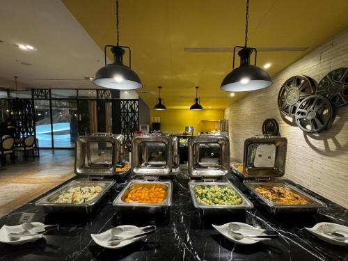 a buffet with several trays of food on a table at 凝萃 水岸隱邸-NCH G11 Hotel in Taichung