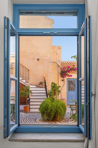an open window with a view of a courtyard at Casa del Sol Suites in Rhodes Town