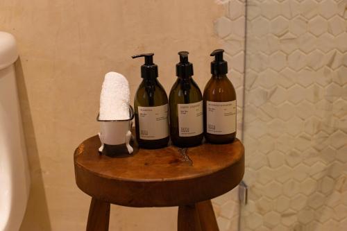 three bottles of wine sitting on a table in a bathroom at DECU DOWNTOWN in Mérida