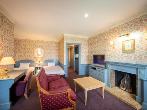a hotel room with a bed and a fireplace at Wellness Forest Nasu in Nasu