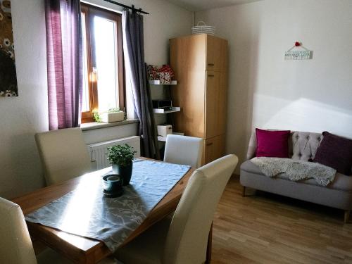 a living room with a table and a couch at Apartment 43 in Oberhöflein