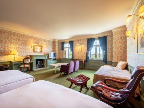 a hotel room with two beds and a fireplace at Wellness Forest Nasu in Nasu