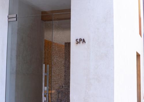 a sign on the side of a building that says spa at DECU DOWNTOWN in Mérida