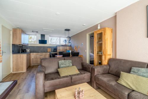 a living room with a couch and a table at Parel 164 in Den Burg