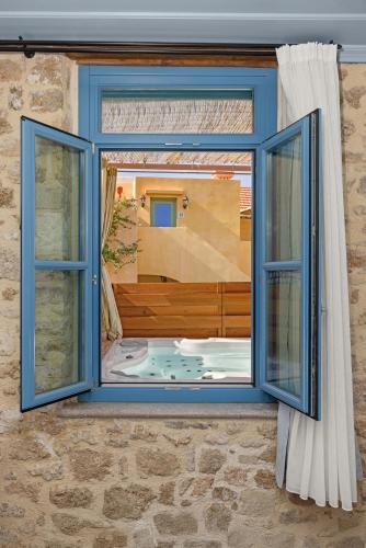 an open window with a view of a bath tub at Casa del Sol Suites in Rhodes Town