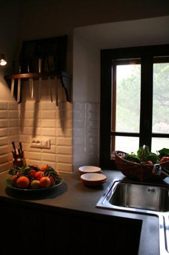 a kitchen with a plate of vegetables on a counter at Podere Marella in I Pieracci