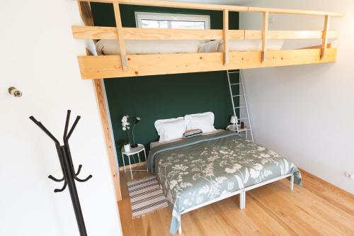 a bedroom with a bunk bed in a room at Quinta da Cerdeira in Seia