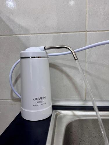 a white mug on a counter next to a sink at MetroCity Square Condominium-3R2B-9 Pax in Kuching