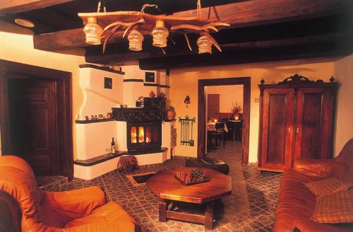 a living room with a couch and a fireplace at Horská chata Stará Horáreň 1 in Dobšiná