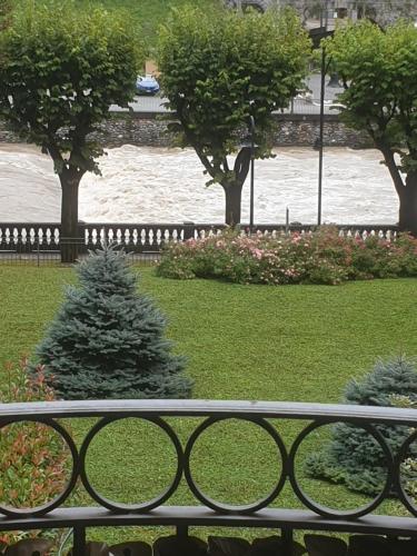 a view of a park with a fence and trees at Casa vacanze ELISA in San Pellegrino Terme