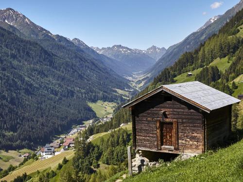 a small wooden building on a hill with a valley at Holiday Home Stark by Interhome in Kappl