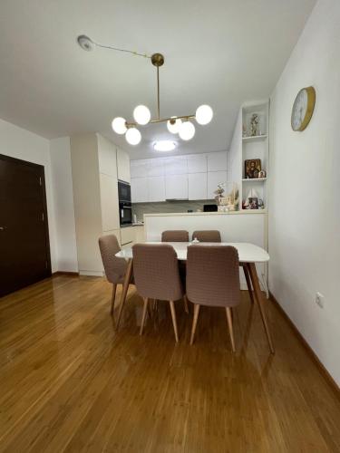 a kitchen and dining room with a table and chairs at Downtown Apartment in Strumica