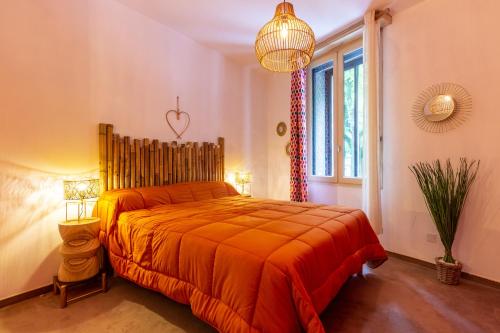 une chambre avec un lit avec un couvre-lit orange dans l'établissement Le Méridien, à Rodez