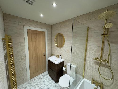 a bathroom with a sink and a toilet and a shower at Sandbed in Hawick