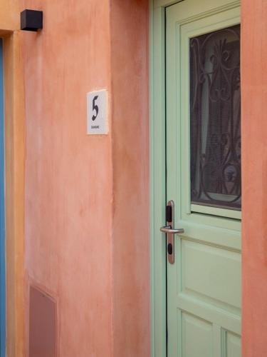 a door of a house with the number six next to it at Casa del Sol Suites in Rhodes Town