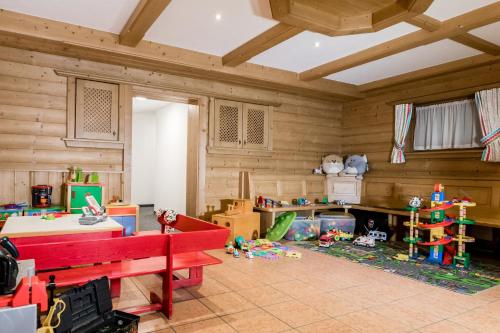 a room with a red bench and toys in it at Hotel Ritterhof Ellmau in Ellmau