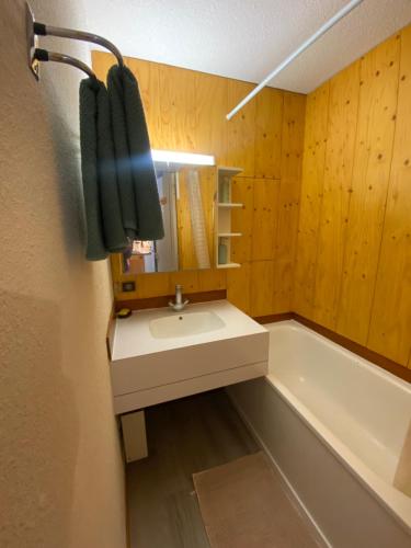 a bathroom with a sink and a bath tub at Chez mon Grand-père in Valmorel