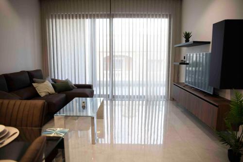 a living room with a couch and a coffee table at Flat 2, stay close to Countryside & Beaches in Mġarr